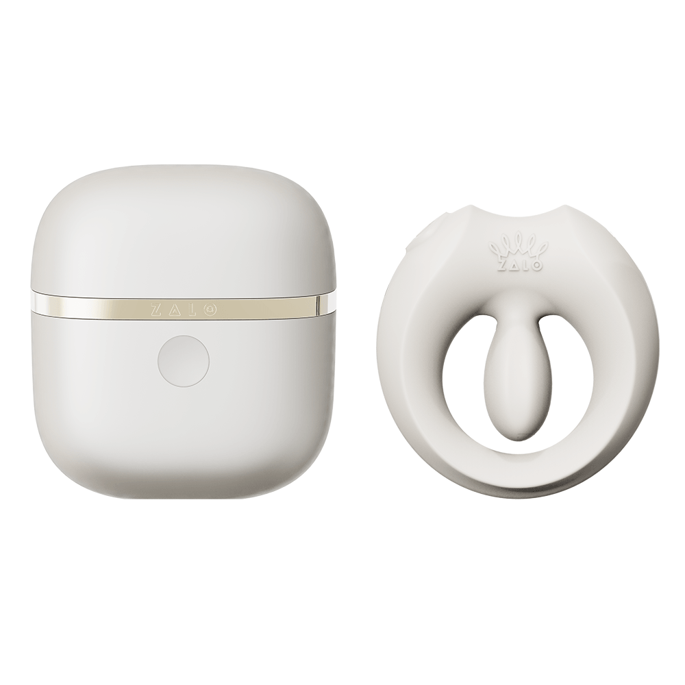 ZALO Apis Vibrating Couples Ring Ivory White next to its sleek charging case in elegant design.