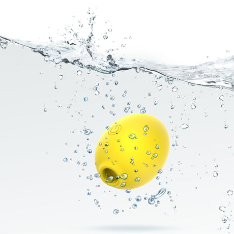 Dreamii Lemon Bliss Suction Stimulator floating in water with bubbles, showcasing its playful design.