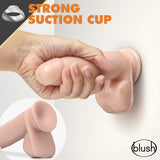 Hand holding a Dr Skin Glide 7 Inch Self Lubricating Dildo Vanilla with strong suction cup on a wall.