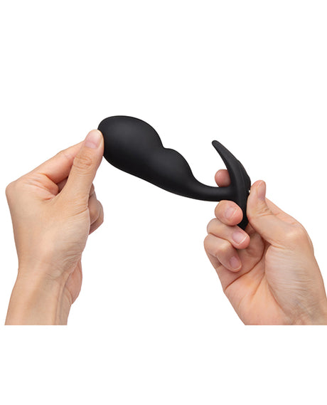 Person holding the b-Vibe Remote Control P-Spot Snug Plug Black showcasing its flexible design and ergonomic shape.