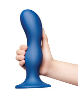 b-Vibe Milk 8.5 inch Curved Anal Trainer with Tapered Tip held in hand, showcasing its ergonomic design.
