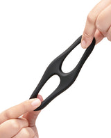 b-Vibe Flex Ring Eight Silicone Cock Ring held between fingers, showcasing its flexible design.