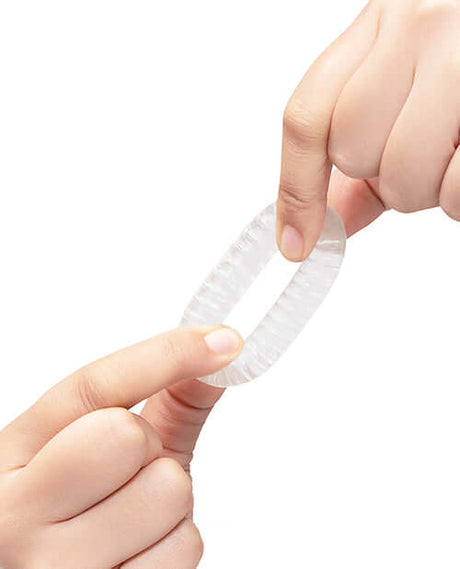 b-Vibe Stretch-Tech Swirl Flexible Secure Fit Cock Ring being held to show its texture and flexibility.
