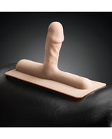 The Cowgirl Bronco Silicone Attachment Vanilla on a saddle, showcasing its realistic design and textures.
