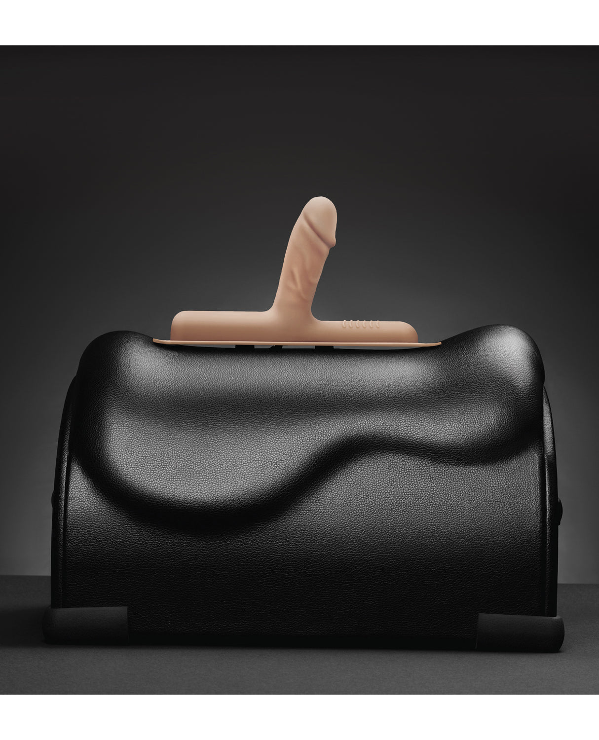 The Cowgirl Bronco Silicone Attachment Vanilla on a black sex machine, showcasing its realistic design and color.