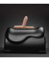 The Cowgirl Bronco Silicone Attachment Vanilla on a black sex machine, showcasing its realistic design and color.
