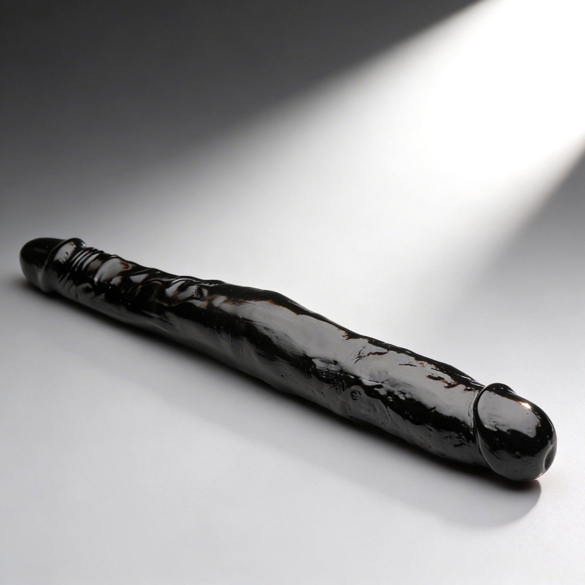 JOCK 13 Inch Tapered Double Dong Black on a smooth surface, showcasing its realistic detailing and dual heads.