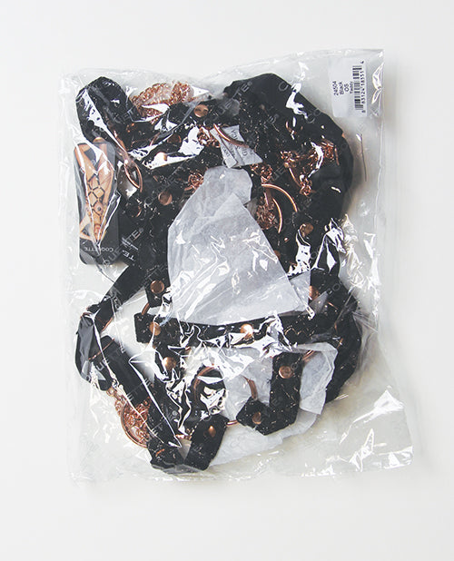 Coquette Your Command Harness Teddy Black Rose Gold in clear packaging with black straps and rose gold hardware.