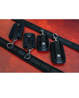 Sei Mio Pretty Thighed Up Thigh Wrist and Ankle Restraint set of black restraints on a red background.