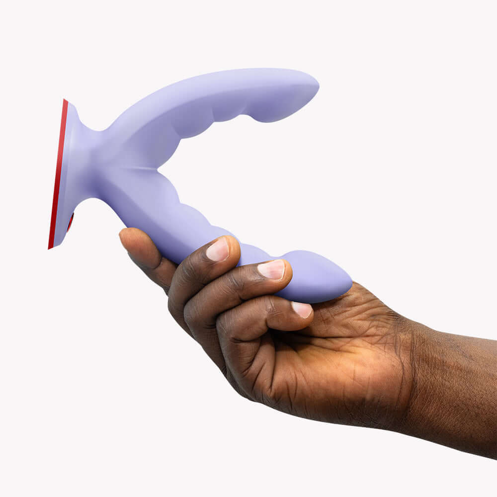 Fun Factory Ryde Dual Stimulation Dildo Purple held in hand, showcasing its ergonomic design and vibrant color.