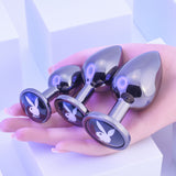 Playboy Pleasure 3 Ways Metal Anal Training Kit Black in hand showcasing three graduated plugs for anal play.