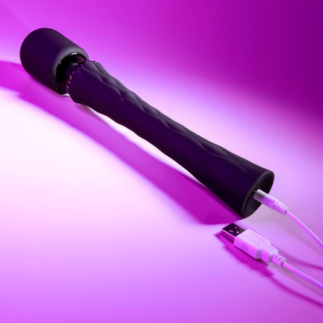 Playboy Royal Silicone Vibrating Wand Massager Black on a pink background with USB charging cable.