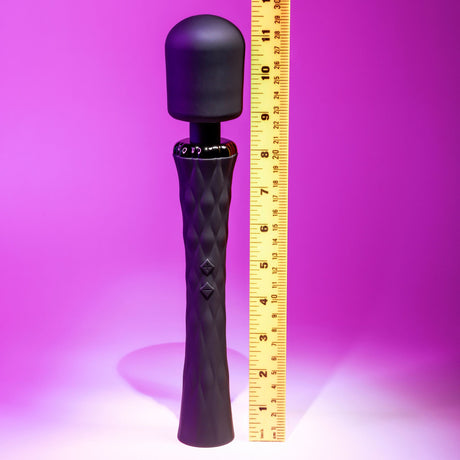 Playboy Royal Silicone Vibrating Wand Massager Black shown next to a ruler for size comparison against a pink background.