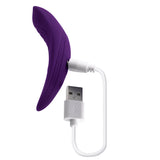 Playboy Our Little Secret Panty Vibrator Purple charging with USB cable for discreet pleasure.