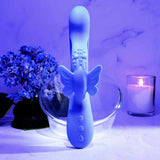 Evolved Butterfly Dreams Silicone Rabbit Vibrator displayed with floral elements and candle ambiance.
