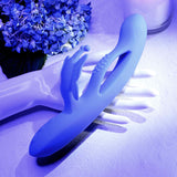 Evolved Butterfly Dreams Silicone Rabbit Vibrator displayed on a hand surrounded by flowers.