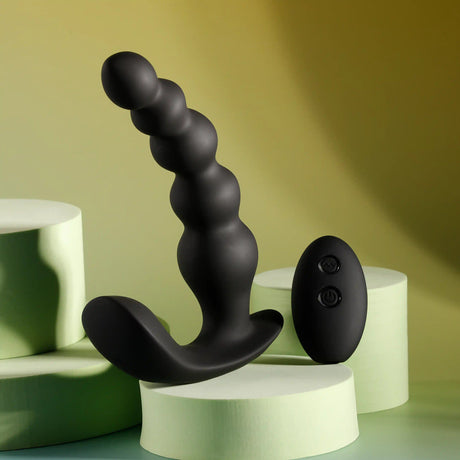 Evolved Bead Me Up Silicone Vibrating Anal Beads Black with remote control on display.