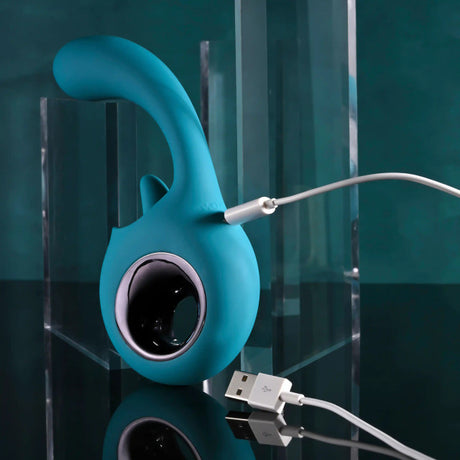 Evolved How Many Licks Silicone Vibrator Blue charging on a sleek surface, showcasing its unique design and features.