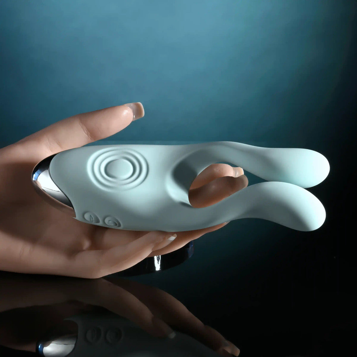Evolved Couples Therapy Silicone Vibrator Green held in hand, featuring flexible antennae and a unique design for shared pleasure.