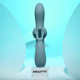 Evolved Take Your Flick Dual Motor Rabbit Vibrator displayed on clear stand against a soft blue background.