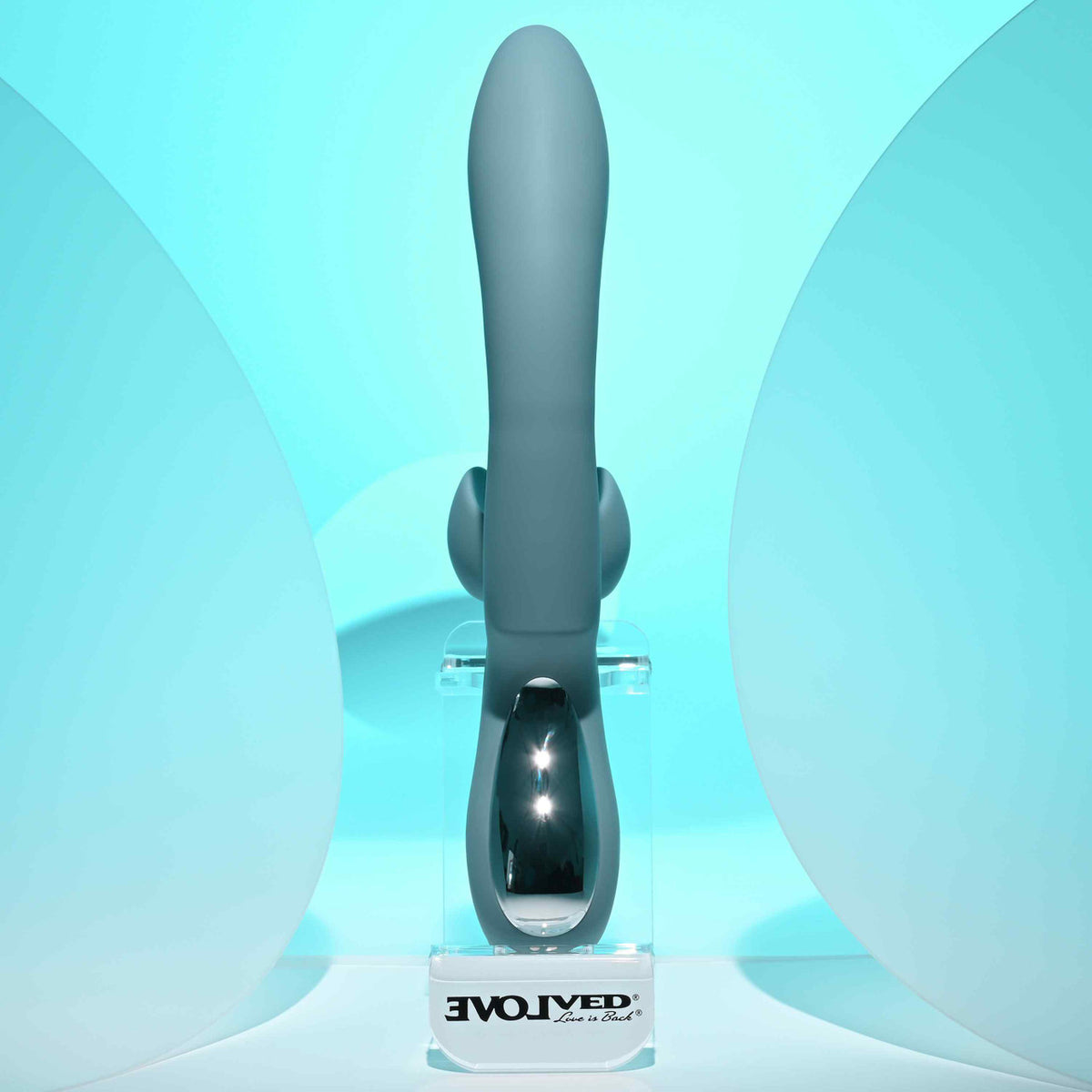 Evolved Take Your Flick Dual Motor Rabbit Vibrator displayed on a stand against a light blue backdrop.