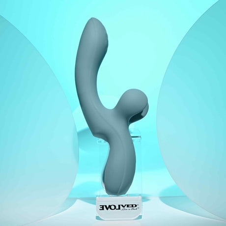 Evolved Take Your Flick Dual Motor Rabbit Vibrator displayed against a soft blue background, showcasing its unique design.