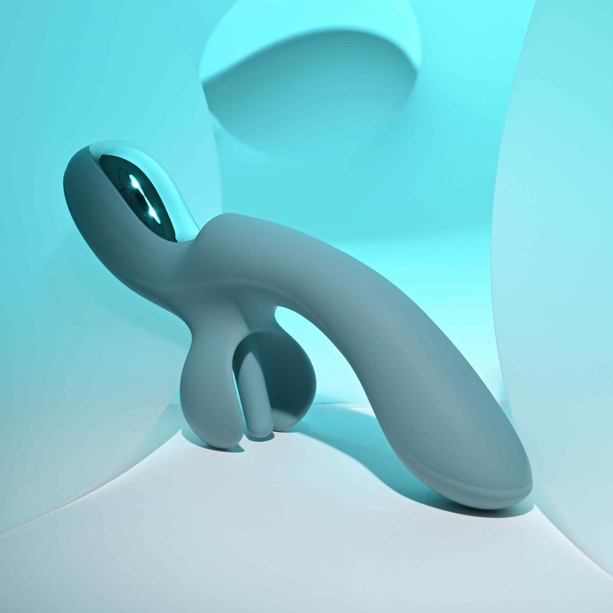 Evolved Take Your Flick Dual Motor Rabbit Vibrator showcasing its flexible design against a soft, blue background.