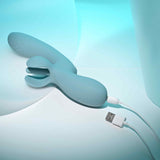 Evolved Take Your Flick Dual Motor Rabbit Vibrator in soft blue, connected for charging, showcasing its dual motor design.