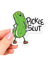 Hand holding a Pickle Slut Funny Vinyl Sticker with a cartoon pickle character.