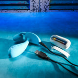 Gender X Wear Me Out Wearable Dual Vibrator Blue with charging cable and battery pack on a blue background.