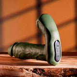 Gender X The Hunk Thrusting Vibrating Dildo Green displayed on a wooden surface, showcasing its dual-shaft design.