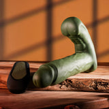 Gender X The Hunk Thrusting Vibrating Dildo Green displayed on wood with remote.