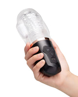 He-Vibe Vibrating Suck Master Male Masturbator held in hand showcasing its design and controls.