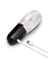 He-Vibe Vibrating Suck Master Male Masturbator with USB charging cable and textured sleeve.
