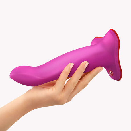 Fun Factory Limba Flex M Bendable Dildo Magenta held in hand, showcasing its flexible design for customizable positioning.