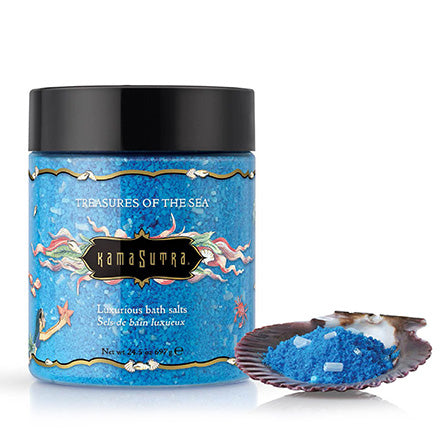 Kama Sutra Treasures Of The Sea Bath Salt jar with blue crystals and shell display beside it.