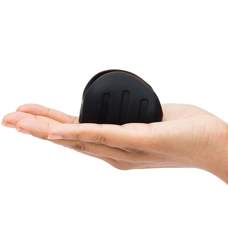 Fifty Shades Of Grey Sensation Vibrating Pleasure Stroker held in hand, showcasing its silky-soft texture and compact design.