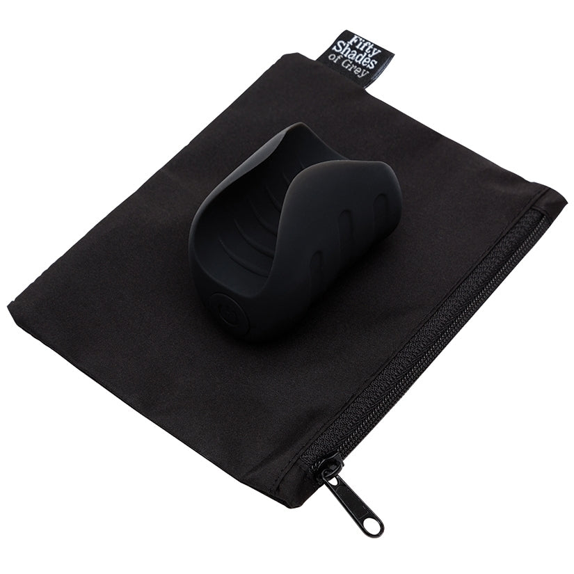 Fifty Shades Of Grey Sensation Vibrating Pleasure Stroker on a black pouch, showcasing its sleek and modern design.