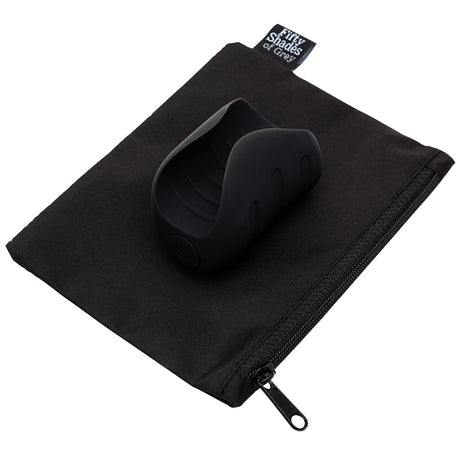Fifty Shades Of Grey Sensation Vibrating Pleasure Stroker on a black pouch, showcasing its sleek and modern design.