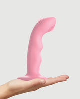 Strap-On-Me Tapping Dildo Wave Vibrator Coral displayed in a hand.