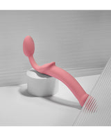 Strap-on-Me Semi-Realistic Bendable Strap-on Pink on a white surface showcasing its elegant design.