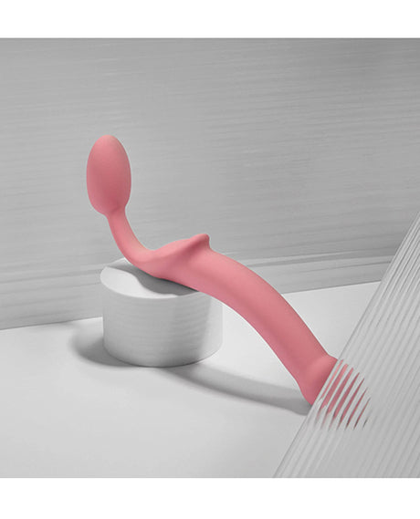 Strap-on-Me Semi-Realistic Bendable Strap-on Pink on a white surface showcasing its elegant design.