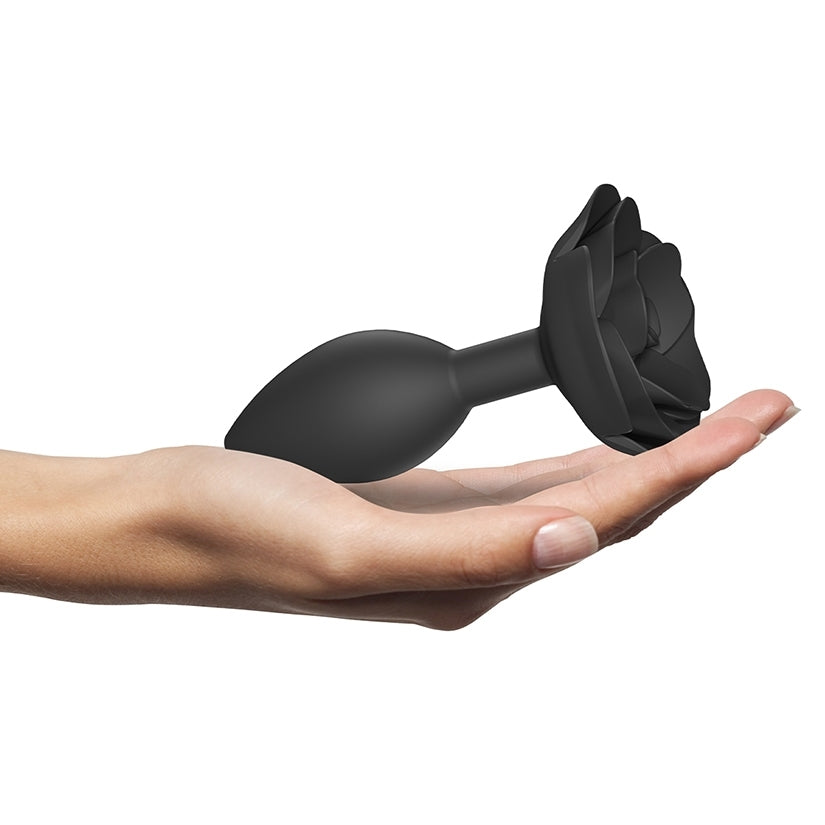 Love to Love Open Roses Silicone Butt Plug Black Onyx Large held in a hand, showcasing its elegant design and smooth surface.