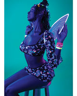 Model wearing Hazy Dayz Shrooms Crop Top Skirt Thong Set Black L XL with wings in a vibrant setting.