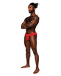 Male Power Sassy Lace Skirt Jock Red L XL modeled by a male model in a playful pose.