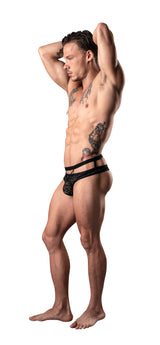 Male Power Lucifer Cutout Thong Black S M modeled by a muscular male with tattoos, showcasing a bold and provocative design.