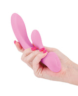 Hand holding the Obsessions Bonnie Vibe Light Pink silicone vibrator for intimate pleasure.