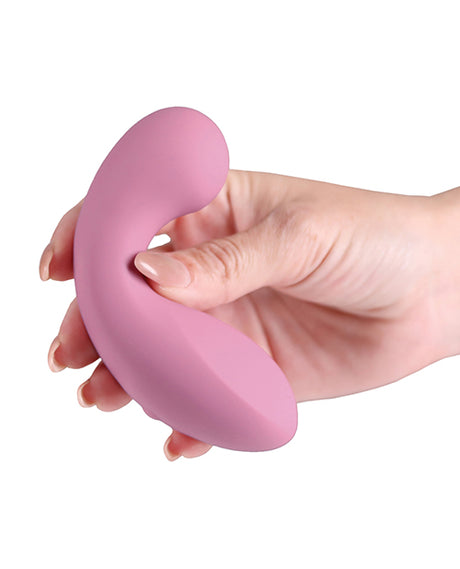 Hand holding the Minnies Flick Flexible Curved Vibe Pink, showcasing its soft silicone design.