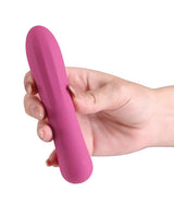 A person holding the X & Os Tempt Silicone Rechargeable Vibe Berry in a hand.