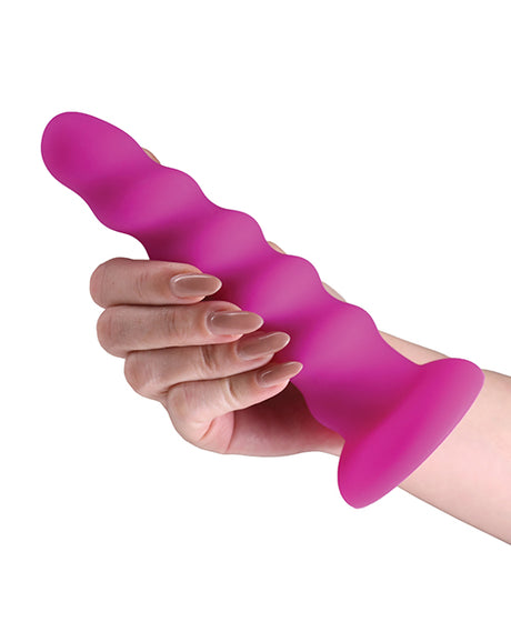 Colours Twist Silicone Dildo 6.5 inches Purple held in a hand, showcasing its contoured design and secure suction cup base.